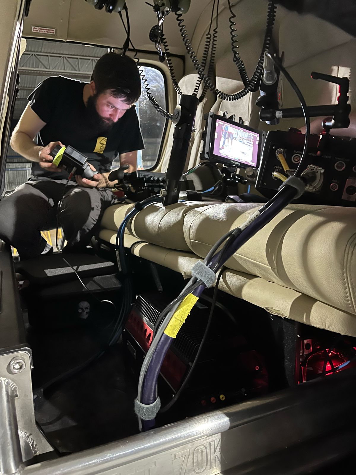 A Brazil Production Services camera assistant sets up focus control on a Stab-C stabilization system on a helicopter for the VFX unit of Sony's Anaconda (feature film).