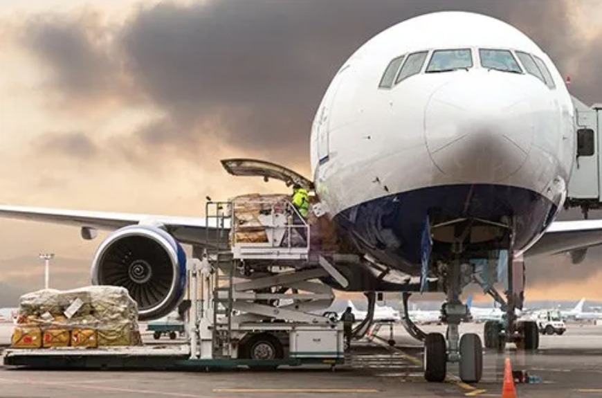 Production gear being loaded into a plane through the work of a freight forwarding service.