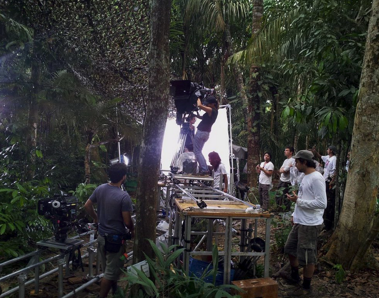 A crew sets up lighting in the middle of the Amazon Rainforest in Brazil.