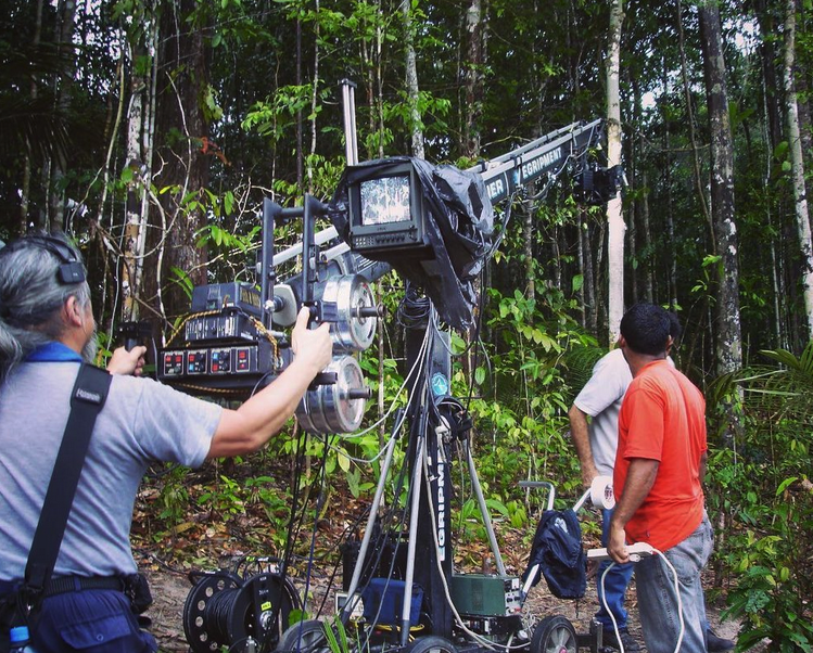 A crew sets up a crane on a film shoot in the jungle near Manaus.