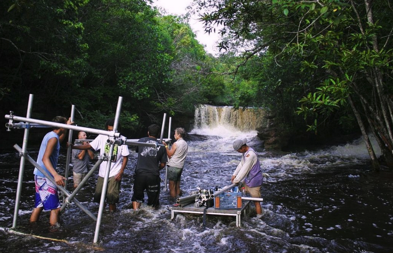 BPS crewmembers get wet as they set up grip equipment near a waterfall in the town of Presidente Figueiredo, in the Brazilian Amazon.
