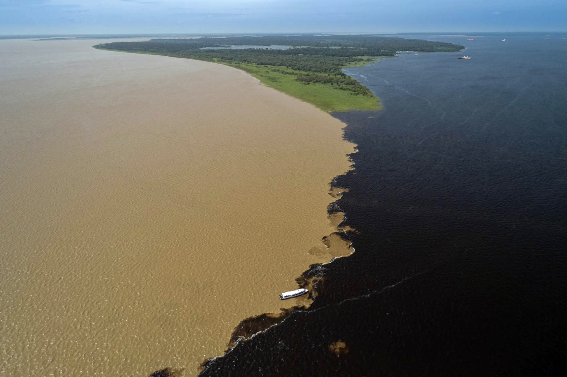An aerial shot of the Meeting of the Waters in Brazil's Amazon Rainforest, near Manaus.