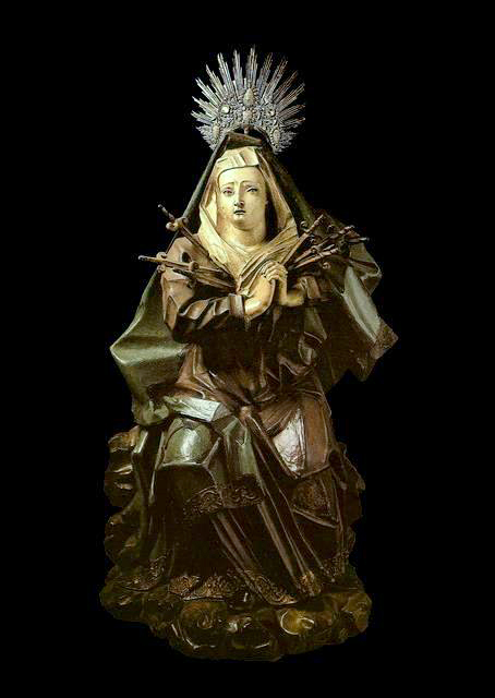 This image shows a wooden sculpture titled Nossa Senhora das Dores (Our Lady of Sorrows), created by the renowned Brazilian Baroque artist Aleijadinho between 1791 and 1812.
