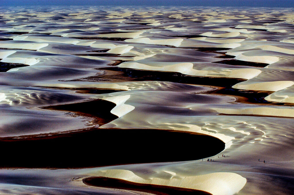 Aerial view of the white dunes and blue lagoons of Lençóis Maranhenses National Park, Brazil, the location scouted by Brazil Production Services for Marvel's Avengers: Infinity War VFX shoot